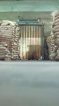 Industrial warehouse - many bags and boxes, working autoloader