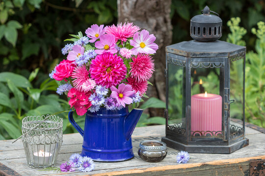 Blumenstrau&szlig; mit pink Dahlie, Sommerastern, Schmuckk&ouml;rbchen, Rosen, Hortensienbl&uuml;ten und  Federnelken in alter Kaffeekanne und vintage Laterne im Sommergarten