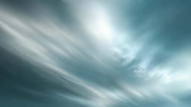 Abstract blurred sky with dramatic clouds in motion, featuring soft gradients of blue and white, creating a peaceful and dreamy atmosphere. Perfect for backgrounds, design, and inspirational visuals