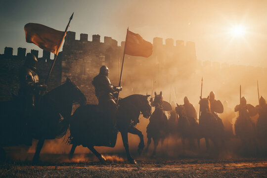 Medieval knight battle at sunset with cavalry and castle walls