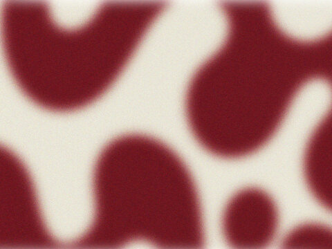 Blurred abstract background of red and white organic shapes resembling animal spots