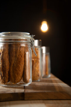 Jars filled with fan,matthi and rusks kept on a shelf in a teastall