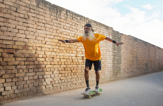 A CHEERFUL OLD MAN ENJOYING SKATING