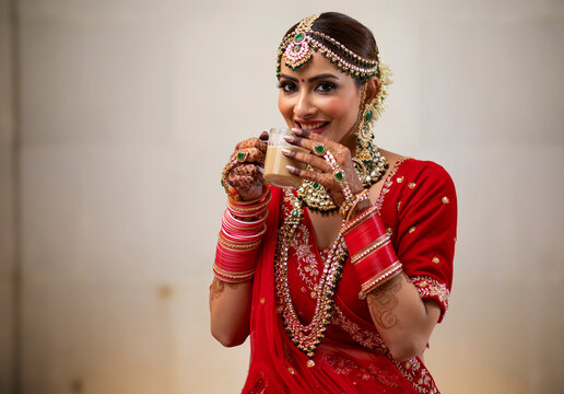 Indian Bride enjoying a cup of tea during her wedding 