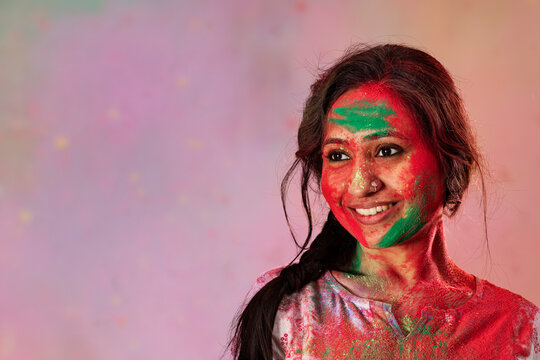 Portrait of a woman celebrating holi with colors on her face
