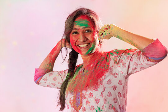 Beautiful woman with gulal on her face playing with colors on Holi