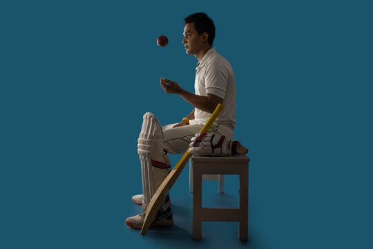 A batsman,Cricketer sitting in dressing room 