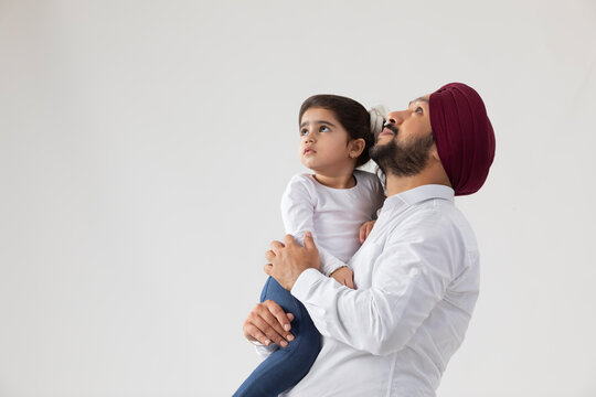 A SIKH FATHER AND DAUGHTER LOOKING ON TOP