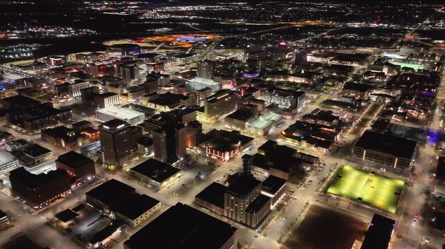 drone footage showcasing the Nebraska State Capitol in Lincoln, Nebraska, with panoramic views of the landmark tower, the famous The Sower statue, downtown skyline, and the surrounding urban landscape