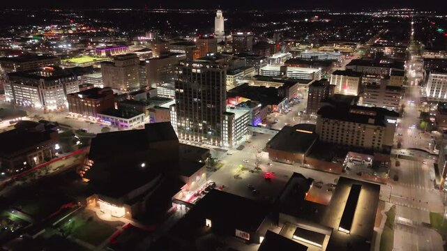 drone footage showcasing the Nebraska State Capitol in Lincoln, Nebraska, with panoramic views of the landmark tower, the famous The Sower statue, downtown skyline, and the surrounding urban landscape
