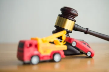Hammer judge gavel and tow truck with car on wooden table white wall background copy space. Vehicle repossession law, bankruptcy, personal financial problem and so on concept. © pla2na