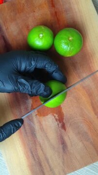 fresh lime, cutting board, black glove, sliced, citrus, fruit, knife, green, chef, kitchen, food, preparation, wooden, ingredient, juicy, sour, tropical, organic, raw, healthy, cooking, chop, slice, h