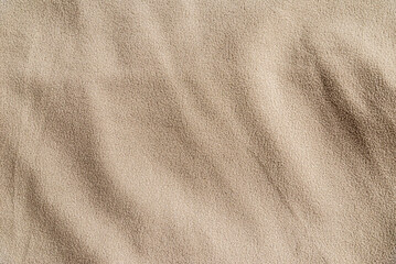 Beige fleece fabric texture background with copy space. Minimalist soft fuzzy textile banner featuring gentle drapery folds. © ARVD73