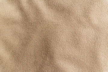 Beige fleece fabric texture background with copy space. Minimalist soft fuzzy textile banner featuring gentle drapery folds. © ARVD73