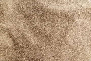 Beige fleece fabric texture background with copy space. Minimalist soft fuzzy textile banner featuring gentle drapery folds. © ARVD73