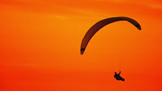 paraglider silhouette at sunset in Hanstholm, Denmark