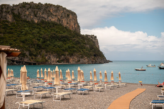 Idyllic Italian beach with rows of sun loungers and umbrellas