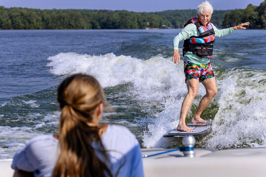 A woman wake surfs on a lake in Alabama