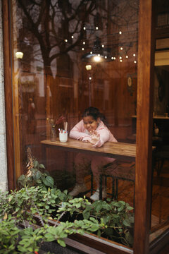 Young biracial girl in a coffee shop