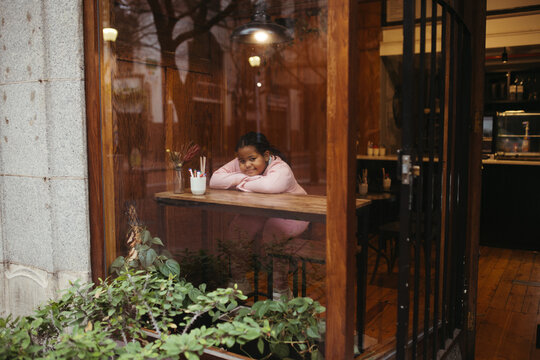 Young biracial girl in a coffee shop