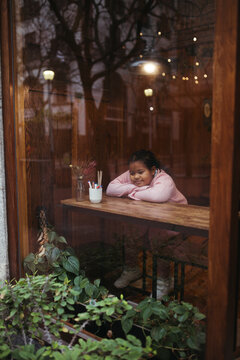 Young biracial girl in a coffee shop