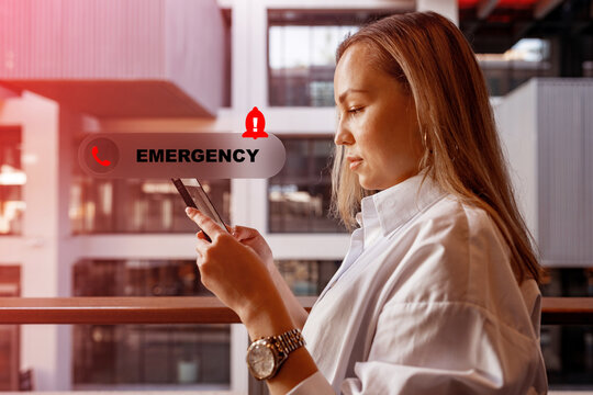 Woman using phone to communicate with emergency service in building during day
