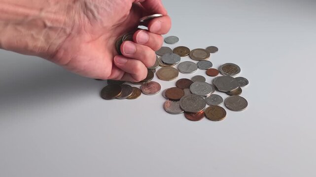 Sorting coins on a flat surface by hand in a simple arrangement