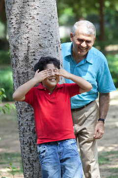 Grandfather and grandson playing hide and seek