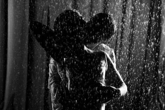 Artistic Silhouette of Dancing Couple in Rain Black and White Photography