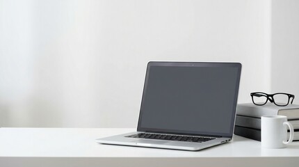 Fototapeta premium Minimalist white office desk with laptop, books, glasses and coffee mug ready for mockup design.