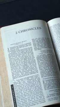 Opening to the Book of 2 Chronicles of the Old Testament in the Holy Bible. New Revised Standard Version. Vertical video.