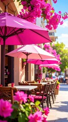 Obraz premium Charming Outdoor Cafe with Pink Umbrellas and Vibrant Bougainvillea on a Sunny Day in a Picturesque Street Setting