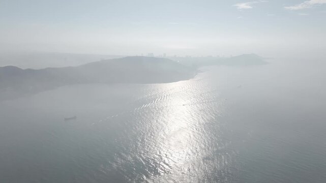Aerial drone footage of container ships sailing across Ganh Rai Bay, Ho Chi Minh City, Vietnam, showcasing global maritime transport, busy shipping routes and coastal logistics.