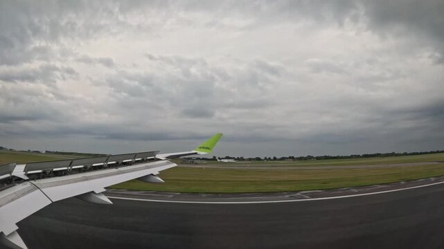 COPENHAGEN, DENMARK - JULY 1, 2024: airBaltic airplane decelerating on runway after landing