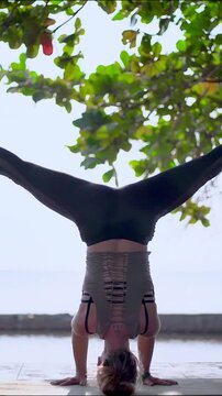 Woman Practicing Yoga Handstand on Beach at Sunset Outdoor Fitness and Wellness Animation