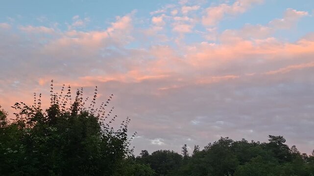 sunset and pink cloudscape in the sky in the mountains