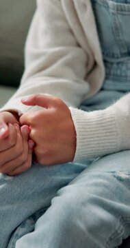 Child, hands and nervous in home with fidget, separation anxiety and scared in living room. Mental health, insecure kid and stimming on couch with worry, coping mechanism and stress on timeout
