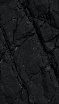 Dark Rock Texture: A close-up view of a dark, rugged rock surface reveals intricate cracks and natural patterns, showcasing the raw beauty of geological formations.