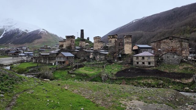 Ancient Svaneti stone defensive towers in Ushguli village, Georgia, remote mountain landscape, travel destination, UNESCO heritage site