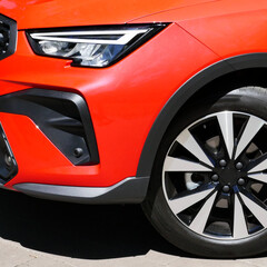 Close up of Intense Red Car Front Wheel and Headlight  © AnyVIDStudio