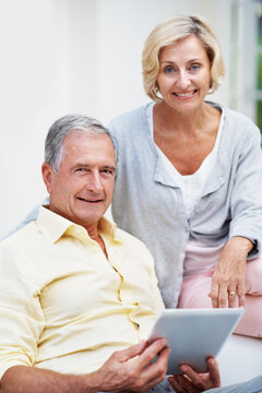 Portrait, tablet and love with old couple on sofa for retirement home review, planning and support. Senior living research, smile and connection with elderly man and woman in lounge of house