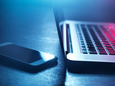 Laptop and smartphone at night