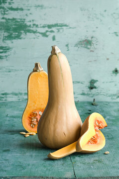 Whole and a sliced butternut squashes