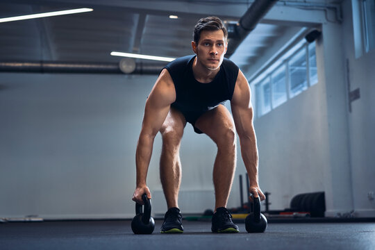 Man doing kettlebell exercise at gym