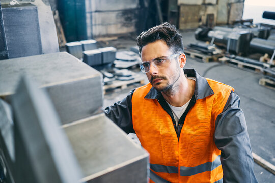 Man wearing protective workwear working in factory