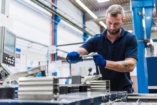 Man working on machine in industrial factory