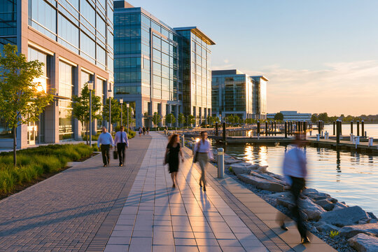 Bayfront office complex with commuters, summer light, summer coastal business concept