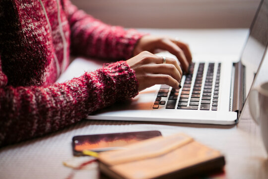 Young woman using laptop, partial view
