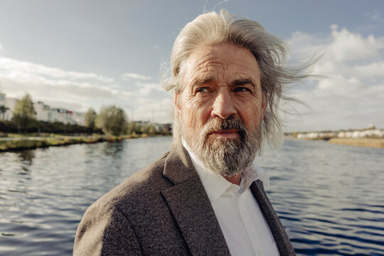 Portrait of serious senior man at a lake