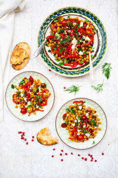 Oriental chickpea salad with feta and flatbread directly above